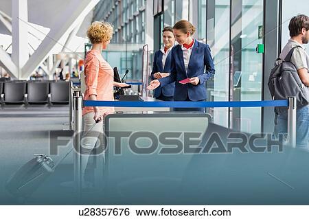 Mature woman on board scanning her ticket on smartphone in airport View Large Photo Image Stock Photograph - Mature woman on board scanning her ticket on smartphone in airport. Fotosearch