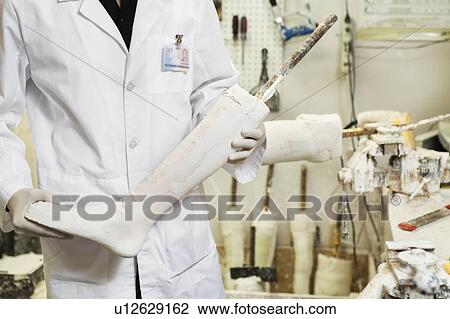 Mid section of a male technician with prosthetic foot View Large Photo Image Stock Image - Mid section of a male technician with prosthetic foot. Fotosearch