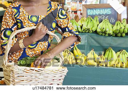 Midsection of African American in traditional wear with vegetable basket at super market View Large Photo Image Stock Image - Midsection of African American in traditional wear with vegetable basket at super market. Fotosearch