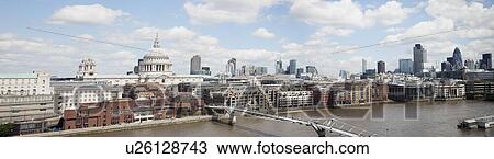 Stock Image - Millennium bridge over River Thames and cityscape, London, England, UK. Fotosearch