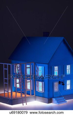 Stock Photo - Model of house with ladder close-up. Fotosearch