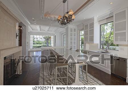 Stock Image - Modern kitchen interior with dining table and chair in luxury villa. Fotosearch