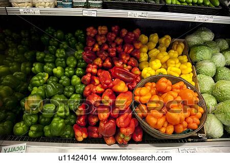 Picture - Multicolored bell peppers on display in produce market. Fotosearch