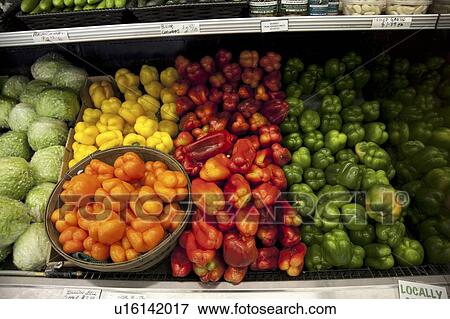 Stock Photo - Multicolored bell peppers on display in produce market. Fotosearch