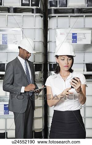 Multiethnic business colleagues using tablet PC and cell phone View Large Photo Image Stock Image - Multiethnic business colleagues using tablet PC and cell phone. Fotosearch