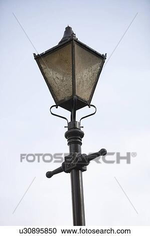 Stock Image - Old fashioned street lantern against clear sky. Fotosearch