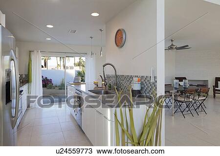 Stock Image - Open kitchen and loving room with slide door to garden. Fotosearch