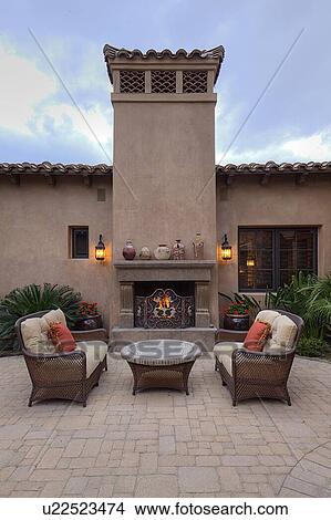 Picture - Outdoor furniture on patio of luxury home.. Fotosearch