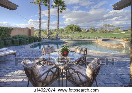 Outdoors table and chair in patio of mansion View Large Photo Image Picture - Outdoors table and chair in patio of mansion. Fotosearch