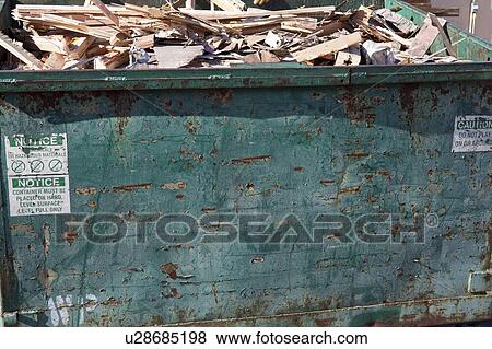 Overflowing dumpster with scrap wood View Large Photo Image Stock Photo - Overflowing dumpster with scrap wood. Fotosearch