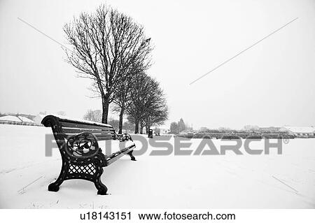 Park bench and park covered in snow View Large Photo Image Stock Image - Park bench and park covered in snow. Fotosearch