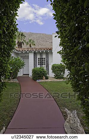 Path through hedge leading to bungalow View Large Photo Image Stock Photo - Path through hedge leading to bungalow. Fotosearch