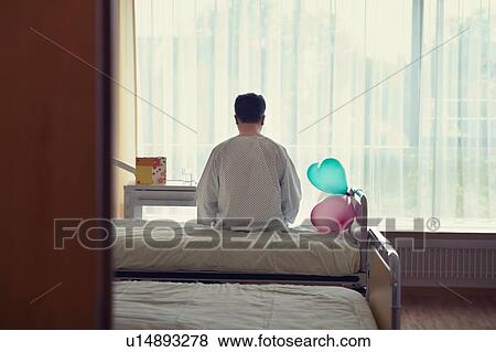 Patient Sitting on Hospital Bed celebrating birthday View Large Photo Image Stock Photo - Patient Sitting on Hospital Bed celebrating birthday. Fotosearch