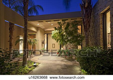 Stock Photo - Paved path through garden leading to front door. Fotosearch