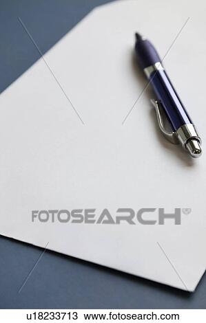 Stock Image - Pencil on a blank paper on dark blue surface. Fotosearch