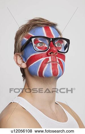 Pensive young Caucasian man with British flag painted on face wearing eyeglasses against white background View Large Photo Image Stock Photo - Pensive young Caucasian man with British flag painted on face wearing eyeglasses against white background. Fotosearch