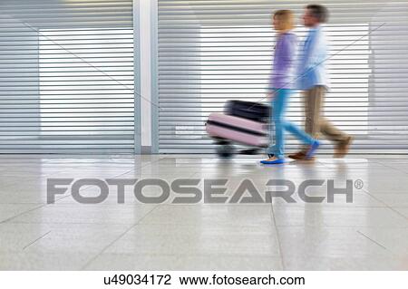 People walking in airport View Large Photo Image Stock Image - People walking in airport. Fotosearch