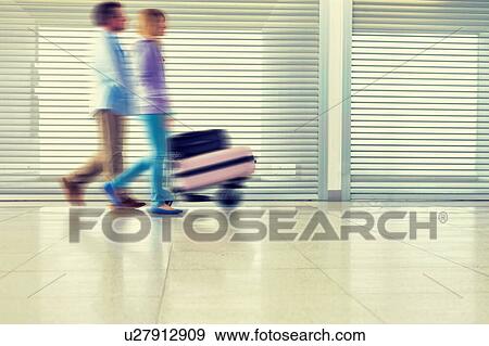 People walking in airport View Large Photo Image Stock Photo - People walking in airport. Fotosearch