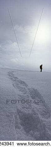 Person standing in winter landscape leaving behind trail of footprints View Large Photo Image Stock Image - Person standing in winter landscape leaving behind trail of footprints. Fotosearch
