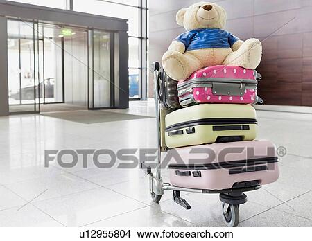 Photo of baggage on cart with lens flare View Large Photo Image Picture - Photo of baggage on cart with lens flare. Fotosearch