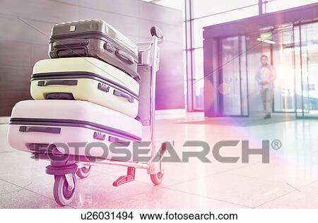 Photo of baggage on cart with lens flare View Large Photo Image Picture - Photo of baggage on cart with lens flare. Fotosearch