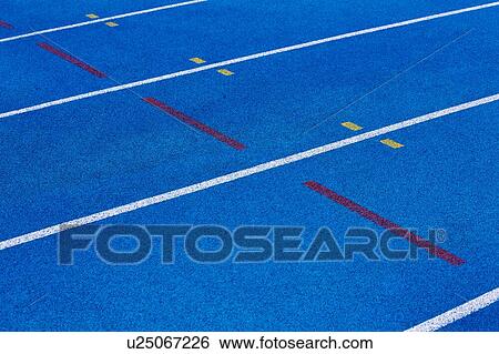 Stock Photograph - Photo of blue stadium tracks. Fotosearch