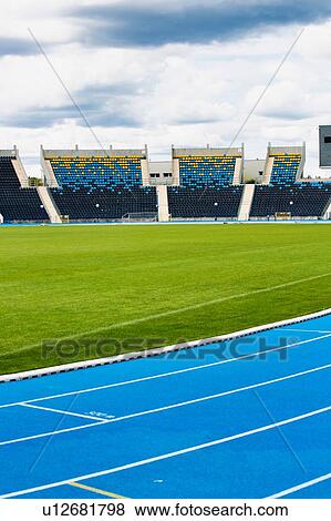Stock Photo - Photo of blue tracking field on stadium . Fotosearch