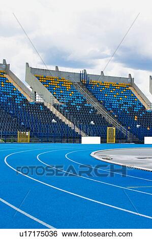 Stock Photograph - Photo of blue tracking field on stadium . Fotosearch
