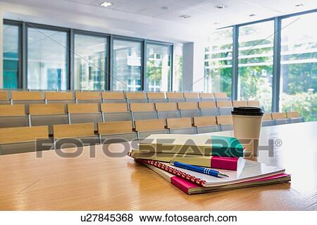 Photo of books and cup of coffee on table in classroom View Large Photo Image Stock Photo - Photo of books and cup of coffee on table in classroom. Fotosearch