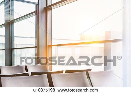 Photo of empty chairs on airport gate with lens flare View Large Photo Image Stock Photo - Photo of empty chairs on airport gate with lens flare. Fotosearch
