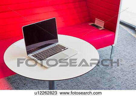 Stock Image - Photo of laptop on table in office. Fotosearch