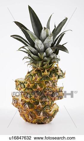 Stock Image - Pineapple cut in slices over white background. Fotosearch