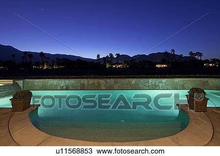 Pool lit from underneath at dusk View Large Photo Image Stock Image - Pool lit from underneath at dusk. Fotosearch