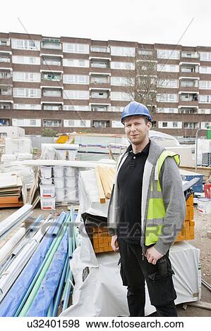 Stock Photo - Portrait of a confident worker standing at construction site. Fotosearch