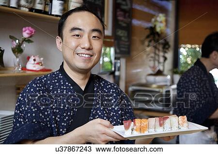 Portrait of a happy chef with sushi in restaurant View Large Photo Image Stock Image - Portrait of a happy chef with sushi in restaurant. Fotosearch