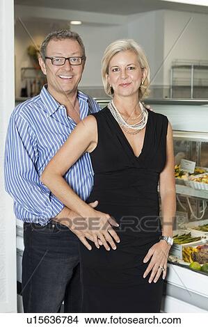 Portrait of a happy mature couple at cafeteria View Large Photo Image Picture - Portrait of a happy mature couple at cafeteria. Fotosearch