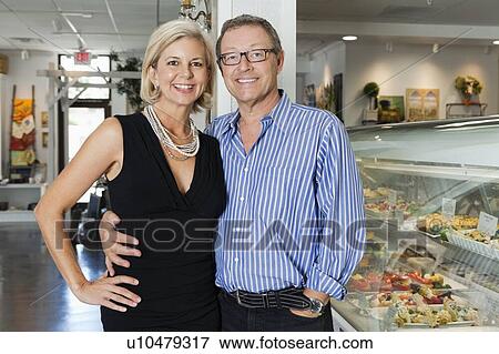 Portrait of a happy mature couple at cafeteria View Large Photo Image Stock Photo - Portrait of a happy mature couple at cafeteria. Fotosearch