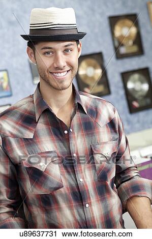 Portrait of a happy young music store owner View Large Photo Image Stock Image - Portrait of a happy young music store owner. Fotosearch