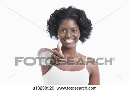 Portrait of a happy young woman gesturing thumbs up over white background View Large Photo Image Stock Image - Portrait of a happy young woman gesturing thumbs up over white background. Fotosearch
