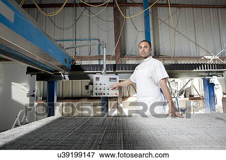 Portrait of a industrial worker operating machinery View Large Photo Image Stock Photo - Portrait of a industrial worker operating machinery. Fotosearch