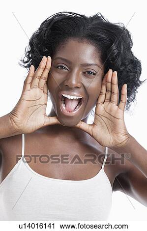 Stock Image - Portrait of a playful young woman shouting over white background. Fotosearch