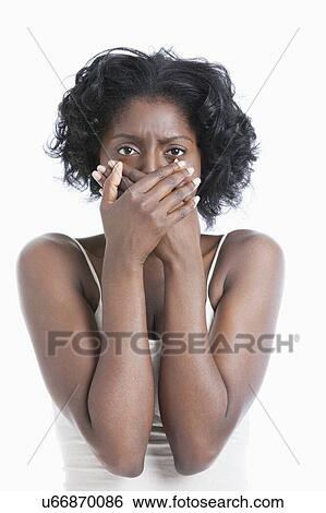 Portrait of a scared young woman with hands over mouth View Large Photo Image Stock Photograph - Portrait of a scared young woman with hands over mouth. Fotosearch