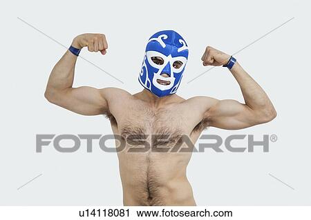 Portrait of a shirtless man in wrestling mask flexing muscles over gray background View Large Photo Image Stock Image - Portrait of a shirtless man in wrestling mask flexing muscles over gray background. Fotosearch