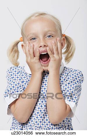 Stock Photograph - Portrait of a surprised girl with mouth open over white background. Fotosearch
