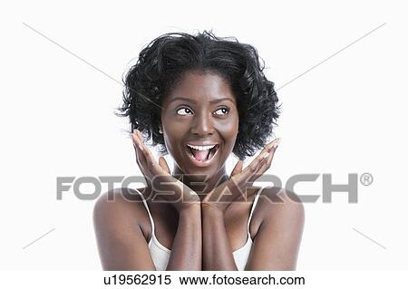 Stock Photography - Portrait of a surprised young woman shouting over white background. Fotosearch