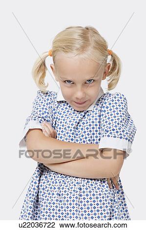 Portrait of a young girl with arms crossed over white background View Large Photo Image Stock Image - Portrait of a young girl with arms crossed over white background. Fotosearch