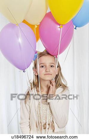 Picture - Portrait of a young girl with party balloons. Fotosearch