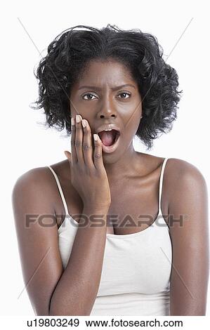 Stock Photo - Portrait of an amazed African American young woman over white background. Fotosearch