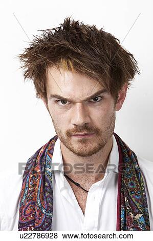Stock Photo - Portrait of an angry young man against white background. Fotosearch