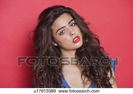 Portrait of an attractive young woman over red background View Large Photo Image Stock Photo - Portrait of an attractive young woman over red background. Fotosearch